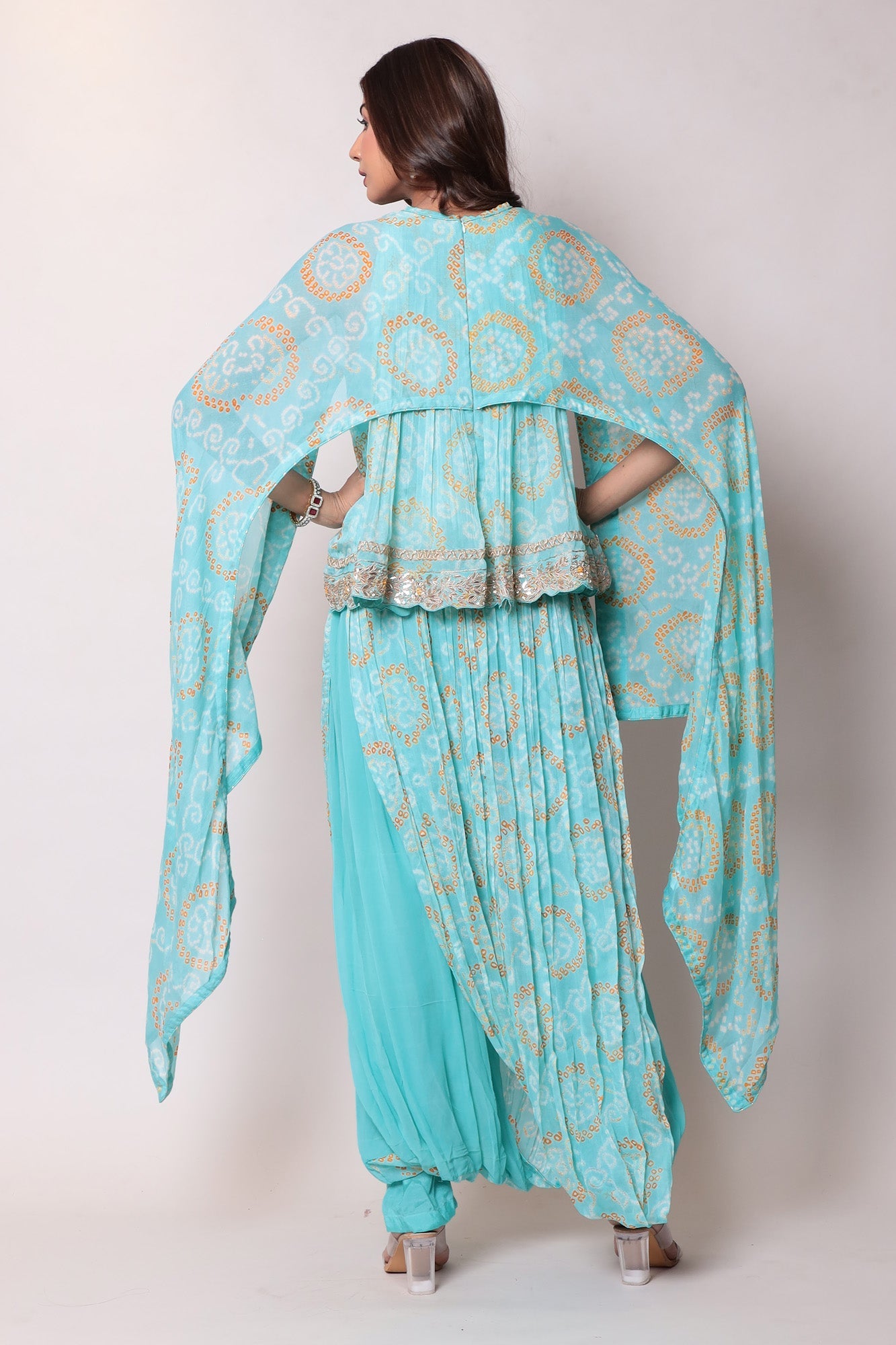 Georgette Bandhej Dhoti style jumpsuit with extended sleeves and peek-a-boo at shoulders.