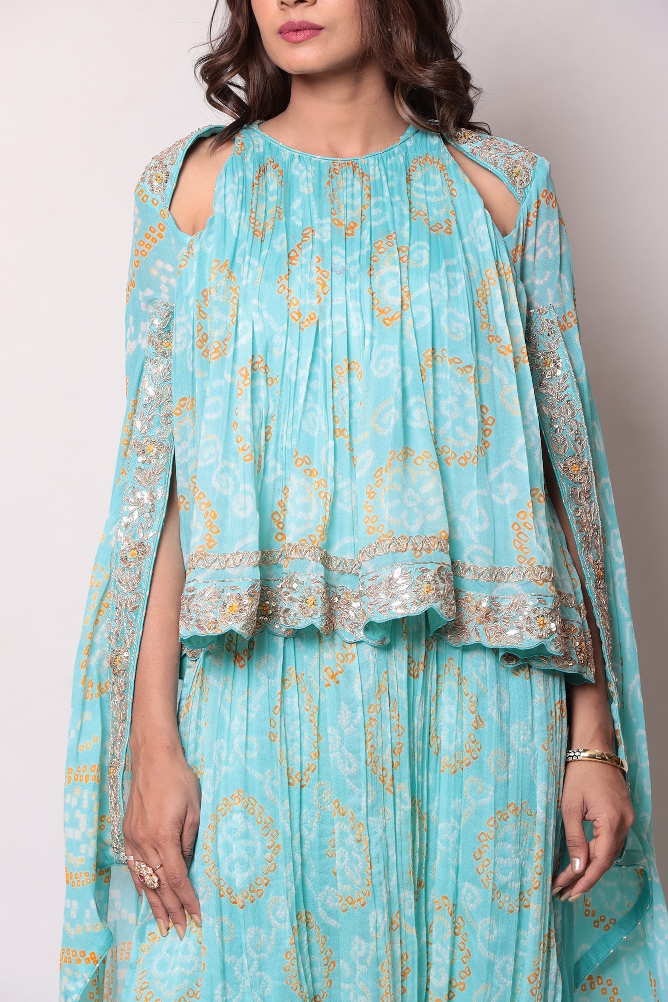 Georgette Bandhej Dhoti style jumpsuit with extended sleeves and peek-a-boo at shoulders.
