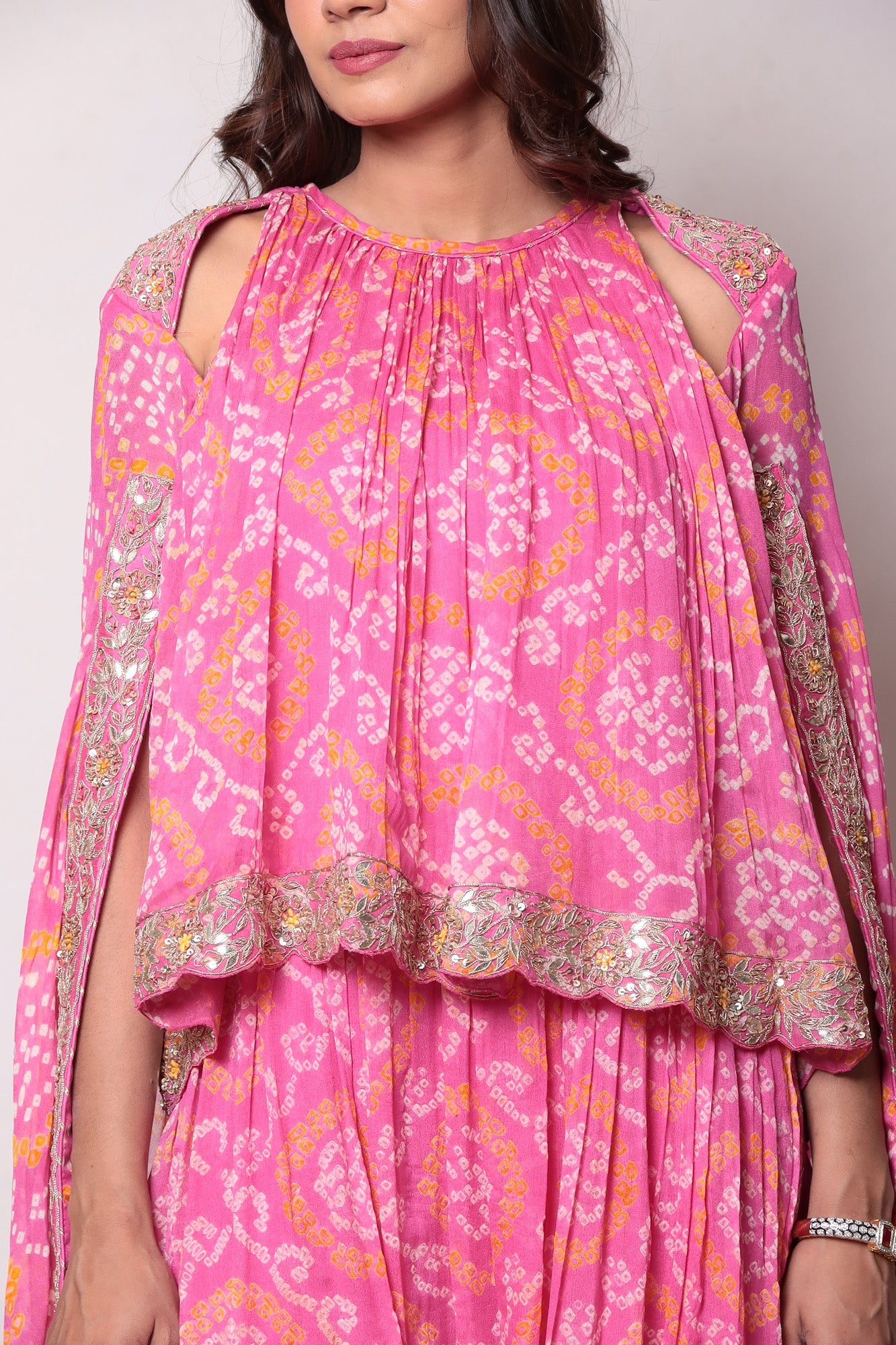 Georgette Bandhej Dhoti style jumpsuit with extended sleeves and peek-a-boo at shoulders.