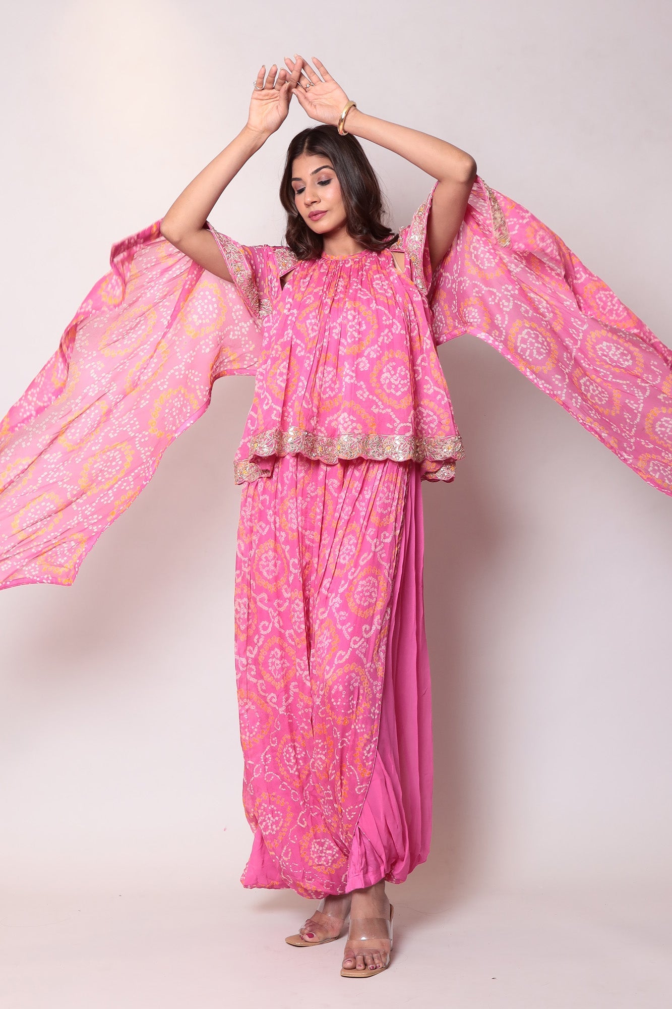 Georgette Bandhej Dhoti style jumpsuit with extended sleeves and peek-a-boo at shoulders.