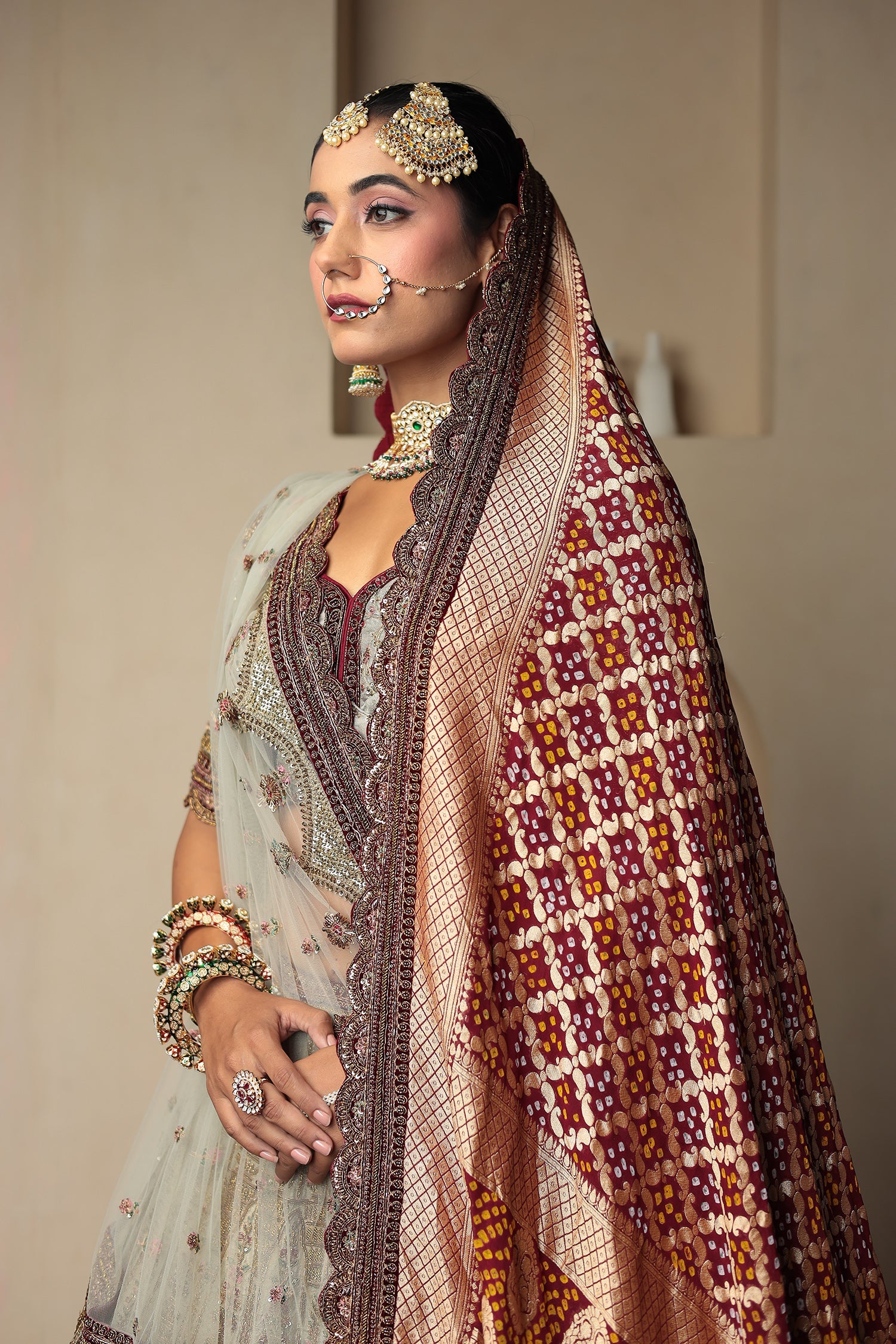 Raw Silk Bridal Lehenga Traditionally Enhanced with Contrast Bandhej Dupatta